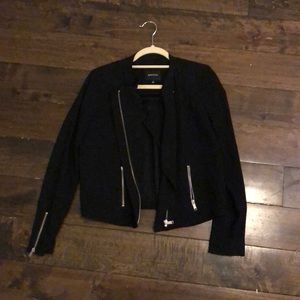 Black crepe jacket with silver zip hardware.